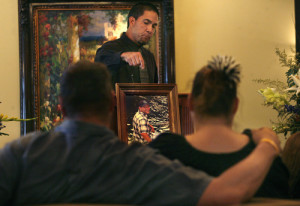 Scott Sommerdorf | The Salt Lake Tribune At the funeral for Daniel Kooyman in Sandy, Saturday, June 8, 2013, Edward V. Aguilar points to the portrait of Daniel Ryan Kooyman, as he talks about the happy times in life and his efforts to help individuals and families dealing with suicide.